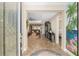 Inviting foyer featuring tile flooring, decorative rug, and a view into the spacious living room at 8445 Sw 93Rd Cir, Ocala, FL 34481
