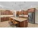 Open kitchen layout with large island, pendant lighting, and stainless steel appliances at 8445 Sw 93Rd Cir, Ocala, FL 34481