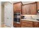 Close-up of kitchen with stainless steel oven, coffee maker, and granite countertops at 8445 Sw 93Rd Cir, Ocala, FL 34481