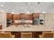 Spacious kitchen with a large granite island, stainless steel appliances, and ample cabinet space at 8445 Sw 93Rd Cir, Ocala, FL 34481