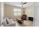 Cozy living room with a comfortable seating arrangement, tile flooring, and a large window for natural light at 8445 Sw 93Rd Cir, Ocala, FL 34481