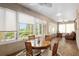 Inviting patio with a dining set, surrounded by windows offering a view of the outdoors at 8445 Sw 93Rd Cir, Ocala, FL 34481