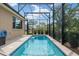 A long swimming pool in a screened-in enclosure offers a private oasis for relaxation and exercise at 8445 Sw 93Rd Cir, Ocala, FL 34481
