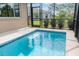 Screened-in pool with crystal clear blue water and tile trim provides a relaxing outdoor space at 8445 Sw 93Rd Cir, Ocala, FL 34481