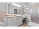 Elegant bathroom featuring a large mirror, vanity with marble countertops, and a glass-enclosed shower at 12333 Se 177Th Loop, Summerfield, FL 34491