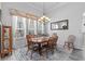 Charming dining area with a wooden table, decorative chandelier, and large windows, perfect for Gathering gatherings at 12333 Se 177Th Loop, Summerfield, FL 34491