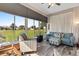 Sunlit Florida room with multiple windows, ceiling fan, and comfy seating for a relaxing indoor-outdoor experience at 12333 Se 177Th Loop, Summerfield, FL 34491