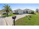 Well-maintained single Gathering home with a lush green lawn, a long driveway, and beautiful landscaping at 12333 Se 177Th Loop, Summerfield, FL 34491