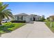 Inviting house with an expansive driveway and well maintained landscaping at 12333 Se 177Th Loop, Summerfield, FL 34491