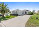 Beautiful home with a lush lawn, a long driveway and a grey exterior at 12333 Se 177Th Loop, Summerfield, FL 34491