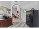 Hallway featuring hard surface floors and arched doorways leading to the rest of the home at 12333 Se 177Th Loop, Summerfield, FL 34491