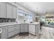 Charming kitchen with gray cabinets, stainless steel appliances, and marble countertops for a modern and inviting space at 12333 Se 177Th Loop, Summerfield, FL 34491