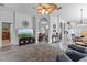 Spacious living room with an entertainment center, ceiling fan, and views into kitchen, dining and sitting room at 12333 Se 177Th Loop, Summerfield, FL 34491