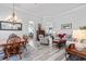 Open-concept living room with ample seating, stylish decor, and abundant natural light with attractive flooring at 12333 Se 177Th Loop, Summerfield, FL 34491