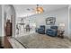 Bright living room featuring plush armchairs, a ceiling fan, and an open layout perfect for relaxing or entertaining at 12333 Se 177Th Loop, Summerfield, FL 34491