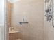 Accessible tiled shower with built-in seat and safety bar for safety and convenience at 12333 Se 177Th Loop, Summerfield, FL 34491