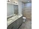 A luxurious bathroom features double sinks, granite counters, and a tiled shower at 3 Dogwood Trl, Ocala, FL 34472