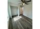 This bedroom features wood-look flooring and a spacious closet with natural light and a modern ceiling fan at 3 Dogwood Trl, Ocala, FL 34472