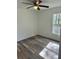 An inviting bedroom offers wood-look flooring, natural light from the window, and a modern ceiling fan at 3 Dogwood Trl, Ocala, FL 34472