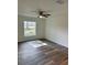 This cozy bedroom features a ceiling fan, natural light, and wood-look floors at 3 Dogwood Trl, Ocala, FL 34472