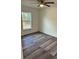 An inviting bedroom offers wood-look flooring, natural light from the window, and a modern ceiling fan at 3 Dogwood Trl, Ocala, FL 34472