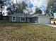 A beautiful single-story home featuring gray paint, a new roof and well-maintained landscaping at 3 Dogwood Trl, Ocala, FL 34472