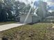 Rear view of a one story home that features an attached 2 car garage and well manicured lawn at 3 Dogwood Trl, Ocala, FL 34472