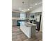 Modern kitchen featuring an island, stylish grey cabinets, and sleek stainless steel appliances at 3 Dogwood Trl, Ocala, FL 34472