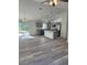 Bright open kitchen featuring an island, stainless steel appliances, and luxury vinyl plank flooring at 3 Dogwood Trl, Ocala, FL 34472