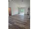 Open-concept living space with elegant wood-look floors and lots of natural light at 3 Dogwood Trl, Ocala, FL 34472