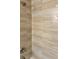 A stylish shower features modern fixtures and elegant beige tiling, enhancing the bathroom's aesthetic at 3 Dogwood Trl, Ocala, FL 34472