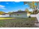 Backyard of the house with a white fence and green grass at 3339 Se 141St Pl, Summerfield, FL 34491