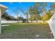 Large grassy backyard enclosed by a white fence at 3339 Se 141St Pl, Summerfield, FL 34491