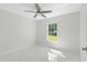 Bedroom with large window, ceiling fan, and marble-look floors at 3339 Se 141St Pl, Summerfield, FL 34491