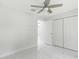 Simple bedroom with white walls, ceiling fan, and tiled floors at 3339 Se 141St Pl, Summerfield, FL 34491