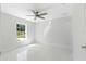 Bright bedroom with tile floors and a ceiling fan at 3339 Se 141St Pl, Summerfield, FL 34491