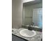 Bathroom features granite-look vanity with undermount sink and large mirror at 6272 Sw 155 Street Rd, Ocala, FL 34473