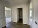 Hallway features wood-look flooring and doors leading to rooms at 6272 Sw 155 Street Rd, Ocala, FL 34473