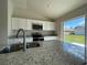 Modern kitchen island featuring a stainless steel sink and granite countertop at 6272 Sw 155 Street Rd, Ocala, FL 34473