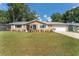 Tan single-story house with a large yard and attached garage at 8389 Sw 108Th Pl, Ocala, FL 34481