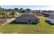 Backyard view with a grassy lawn and a sliding glass door and a simple patio space at 3654 Sw 149 Ter, Ocala, FL 34481