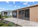 View of the screened lanai and paver patio with lush landscaping in the private backyard at 7709 Sw 86Th Ct, Ocala, FL 34481