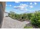 Paver walkway and lush landscaping create a private and inviting backyard at 7709 Sw 86Th Ct, Ocala, FL 34481