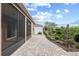 Stone paver walkway and mature landscaping along screened lanai provide a tranquil outdoor space at 7709 Sw 86Th Ct, Ocala, FL 34481