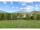 The backyard is landscaped with green shrubs, lawn, and a screened-in patio at 7709 Sw 86Th Ct, Ocala, FL 34481