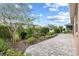 Brick patio and landscaped yard with mulched garden beds and an inviting outdoor space at 7709 Sw 86Th Ct, Ocala, FL 34481