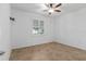 Bright bedroom with a ceiling fan, window with shutter-style blinds, and neutral tile flooring at 7709 Sw 86Th Ct, Ocala, FL 34481