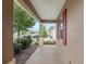 View from covered porch featuring decorative columns, landscaping and neighborhood at 7709 Sw 86Th Ct, Ocala, FL 34481