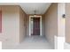 Front door featuring covered porch, security screen and neutral paint at 7709 Sw 86Th Ct, Ocala, FL 34481