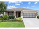 Attractive single-story home with well-maintained lawn, tasteful landscaping and covered porch at 7709 Sw 86Th Ct, Ocala, FL 34481